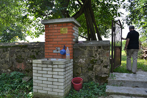Gate, steps, and washing basin at the cemetery entrance
