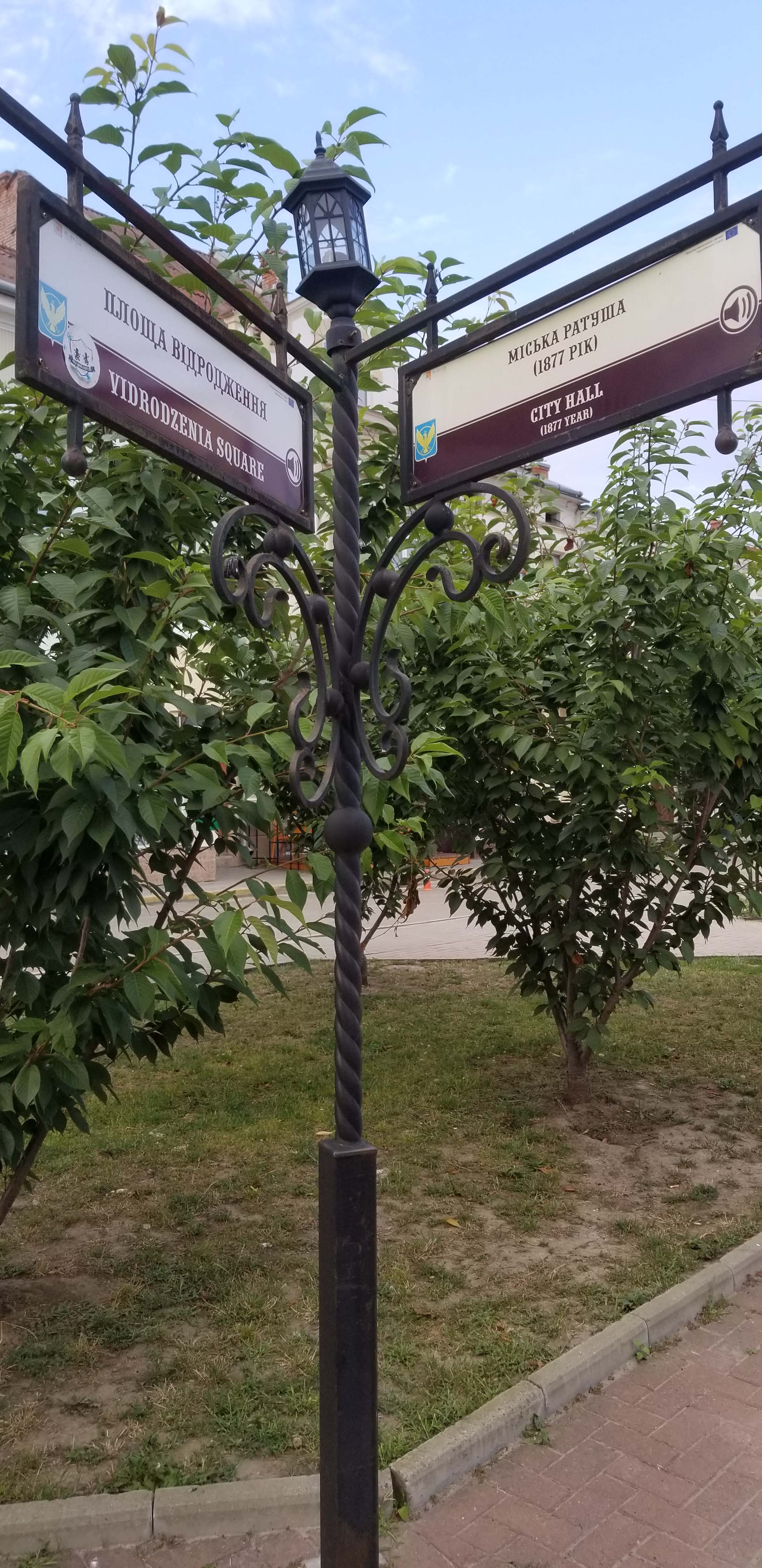 Street sign with City Hall and Vidrodzenia
                  Square