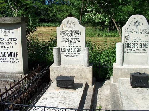 Headstones of Regina Süsser and Elias Süsser behind an iron fence