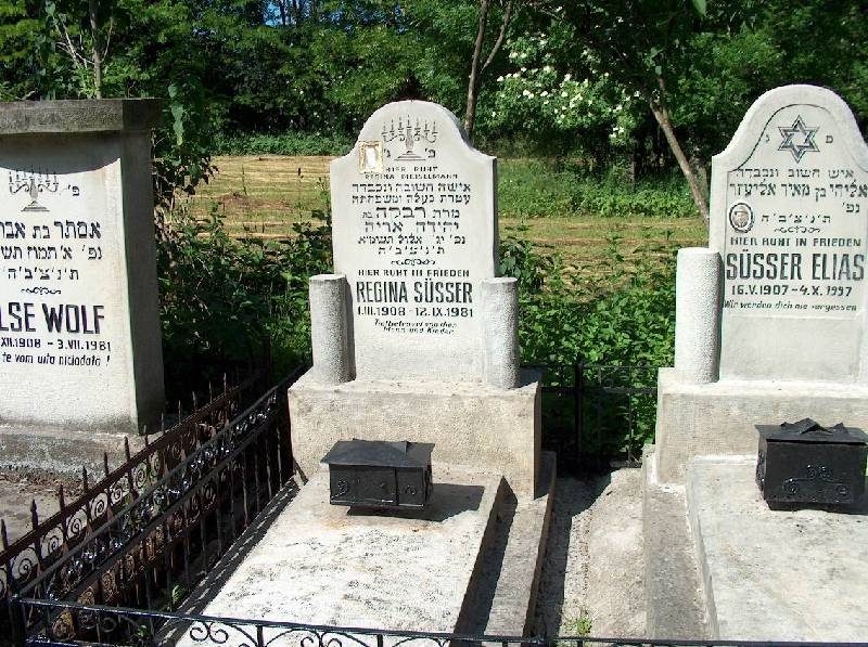 Headstones of Regina Süsser and Elias Süsser behind an iron fence