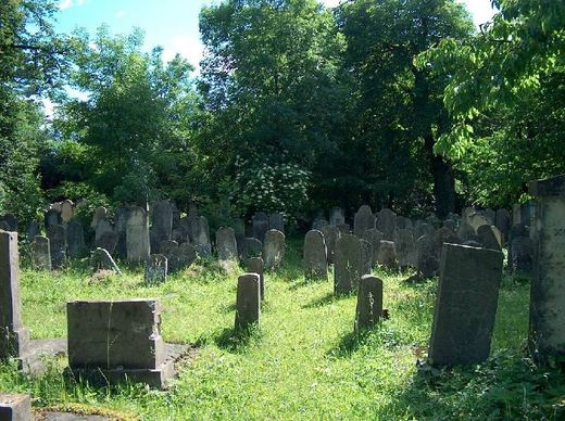 A grassy section with scattered headstones