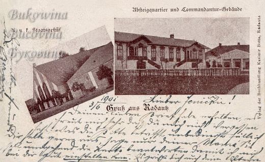 A stud farm building with a steep roof, and a long building with carved gables and twin outside stairs; handwritten message