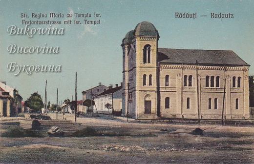 Coloured view of a yellow domed temple with arched windows on a wide dirt street lined with low houses