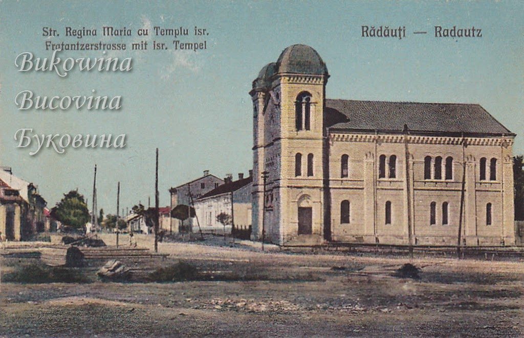Coloured view of a yellow domed temple with arched windows on a wide dirt street lined with low houses