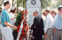 The placing of wreaths at the Memorial Stone, Mr. Pessach Tunkelshwartz in the center , Radzyn, 14.8.95.