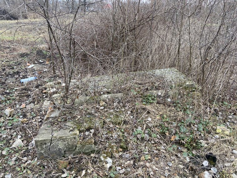 Collapsed and overgrown gravestones in the Old Cemetery at Savran
