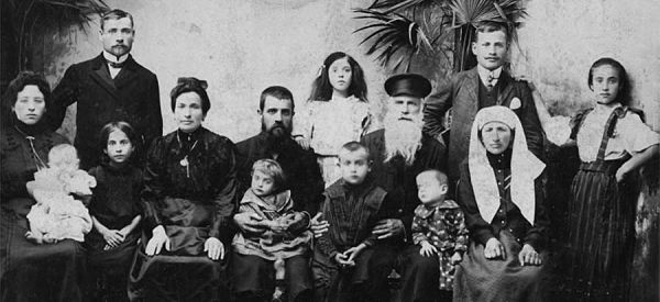 The family to the right is the Joseph & Toba (nee Sklarsky) Linderman family (seated), their son Motl and daughter-in-law Gitl Seri (standing). The children near the patriarch are, most likely, son Moshe on the left and daughter Sara between the couple, although the existence of a daughter is not confirmed. The families to the left of the Linderman's are not identified, but are thought to be related to Toba Sklarsky Linderman. Circa 1896. Submitted by Vivian Linderman who would welcome any clarification on identities.