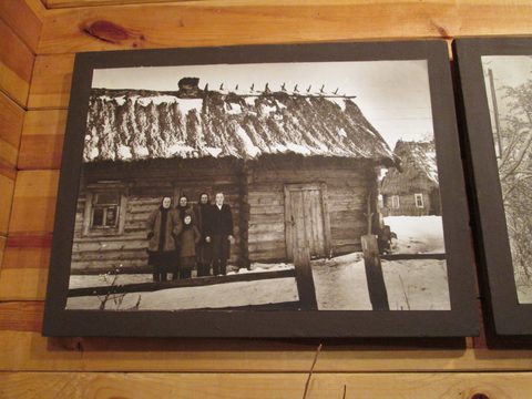 Photo of a family by their home at the Folk Museum in Motol