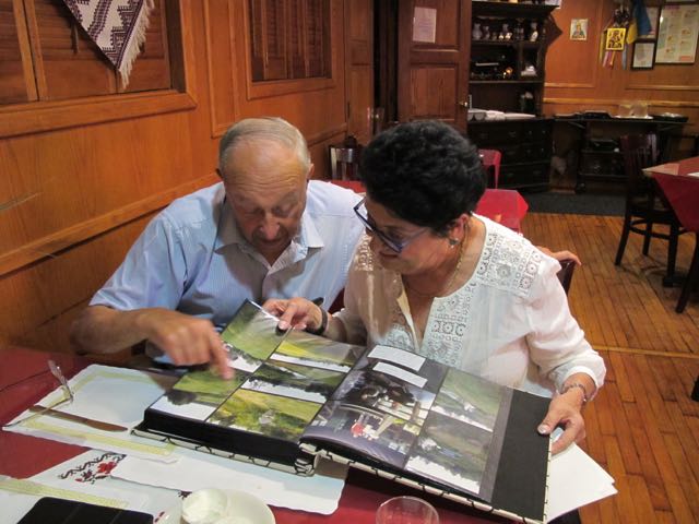 Ken
                                and Barbara looking at photographs from
                                Narewka.