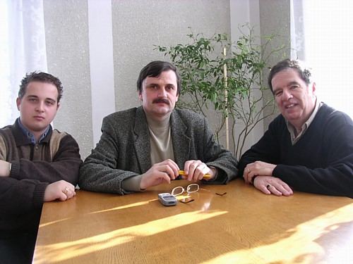 The author with Mihai Colibaba and the Vice-Mayor of Radauti at a table