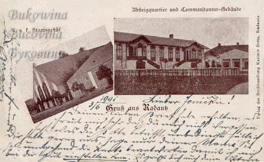 A stud farm building with a steep roof, and a long building with carved gables and twin outside stairs; handwritten message